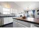 Bright kitchen featuring white cabinets, stainless steel appliances, a breakfast bar and hardwood floors at 10373 Cerulean Dr, Noblesville, IN 46060