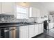 This bright kitchen features white cabinets, stainless steel appliances, and stylish backsplash at 10373 Cerulean Dr, Noblesville, IN 46060