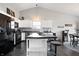 Bright kitchen features white cabinets, black appliances, a breakfast bar and hardwood floors at 10373 Cerulean Dr, Noblesville, IN 46060