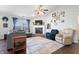 Inviting living room with a fireplace, large windows, ceiling fan, hardwood floors and an open concept design at 10373 Cerulean Dr, Noblesville, IN 46060