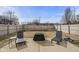 Backyard with a concrete patio, seating, firepit, and wood fence at 10613 Glenayr Dr, Camby, IN 46113