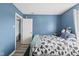 Bedroom featuring blue walls, plush pillows, and natural light at 10613 Glenayr Dr, Camby, IN 46113