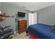 Bedroom showcasing a dark-wood dresser, a ceiling fan, and gamer-themed wall decor at 10613 Glenayr Dr, Camby, IN 46113