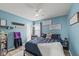 Bedroom with light-blue walls, a ceiling fan, and decoratively themed accents at 10613 Glenayr Dr, Camby, IN 46113