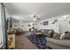 Inviting living room featuring hardwood floors, ceiling fan, and comfortable seating arrangement at 10613 Glenayr Dr, Camby, IN 46113