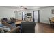 Comfortable living area with hard wood floors, ceiling fan, and large windows at 10613 Glenayr Dr, Camby, IN 46113