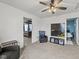 Cozy living area featuring neutral carpet, a ceiling fan, an accent chair, and doorways to adjoining rooms at 10613 Glenayr Dr, Camby, IN 46113