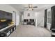 Upstairs loft featuring two TVs on a console table, a ceiling fan, and a pegboard wall organizer at 10613 Glenayr Dr, Camby, IN 46113
