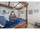 Main bedroom showcasing a four-poster bed, light-blue walls, wood-look floors, and light-colored trim at 10613 Glenayr Dr, Camby, IN 46113