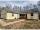 Charming ranch-style home with light yellow siding, a welcoming front porch, and a well-manicured lawn at 1195 Hinson Rd, Martinsville, IN 46151