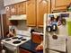 Cozy kitchen featuring wooden cabinets, white appliances, and practical layout at 1195 Hinson Rd, Martinsville, IN 46151