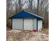 This metal shed has a blue roof at 1195 Hinson Rd, Martinsville, IN 46151