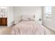 Comfortable bedroom features plush carpet, stylish headboard and great natural lighting through the window at 1230 Maumee Ct, Greenfield, IN 46140