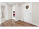 Open foyer with hardwood floors, white door, and view of a bedroom at 1230 Maumee Ct, Greenfield, IN 46140