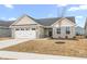 Charming single-story home with stone accents, attached garage, landscaping, and a blue sky at 1230 Maumee Ct, Greenfield, IN 46140