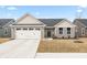 Charming single-story home with stone accents, attached garage and well manicured yard at 1230 Maumee Ct, Greenfield, IN 46140