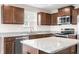 Modern kitchen features stainless steel appliances, granite countertops, wooden cabinets and an island at 1230 Maumee Ct, Greenfield, IN 46140