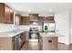 Bright kitchen featuring granite countertops, stainless steel appliances, and wood floors at 1230 Maumee Ct, Greenfield, IN 46140