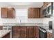 Cozy kitchen features stainless steel appliances, granite countertops, wooden cabinets and an island at 1230 Maumee Ct, Greenfield, IN 46140