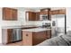Well-equipped kitchen with stainless steel appliances, granite countertops, and wood cabinetry at 1230 Maumee Ct, Greenfield, IN 46140