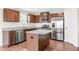 Attractive kitchen with stainless steel appliances, granite countertops, an island, and wood cabinetry at 1230 Maumee Ct, Greenfield, IN 46140
