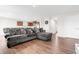 Open-concept living room with hardwood floors and a large comfortable gray sectional at 1230 Maumee Ct, Greenfield, IN 46140