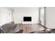 Bright living room with hardwood floors, entertainment center, and large windows at 1230 Maumee Ct, Greenfield, IN 46140