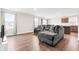 Open-concept living room with hardwood floors, gray sectional, kitchen, and natural light at 1230 Maumee Ct, Greenfield, IN 46140
