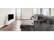 Bright living room with hardwood floors, entertainment center, large windows and gray sectional at 1230 Maumee Ct, Greenfield, IN 46140