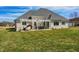 A sprawling backyard showcasing the patio with a pergola, and well-maintained lawn at 1434 Manchester Dr, Danville, IN 46122