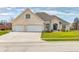 Beautiful brick home featuring a three-car garage, well-manicured lawn, and inviting entrance at 1434 Manchester Dr, Danville, IN 46122