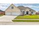Charming white brick home with a three-car garage and well-manicured front lawn at 1434 Manchester Dr, Danville, IN 46122