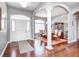 Bright foyer showcasing hardwood floors, a decorative column, and an open dining area at 1434 Manchester Dr, Danville, IN 46122