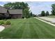 Well-maintained front yard featuring green grass and mature trees, creating a welcoming curb appeal at 1434 Manchester Dr, Danville, IN 46122