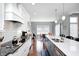 Bright kitchen featuring a large island, hardwood floors, custom cabinets, and stainless steel appliances at 1434 Manchester Dr, Danville, IN 46122