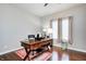 Home office featuring modern desk, wood floors, and natural light from the window at 1434 Manchester Dr, Danville, IN 46122