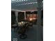 Cozy outdoor patio with pergola, illuminated by string lights, and a dining table at 1434 Manchester Dr, Danville, IN 46122