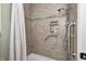 Tiled walk-in shower features a handheld shower head and grab bars for accessibility at 1434 Manchester Dr, Danville, IN 46122