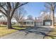 Charming single-story home features a stone facade, red metal roof, and mature trees in the front yard at 1780 S Mauxferry Rd, Franklin, IN 46131