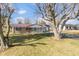View of the property featuring a stone facade, red metal roof, and a well maintained front lawn at 1780 S Mauxferry Rd, Franklin, IN 46131