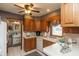 Functional kitchen features wood cabinets, white tile floors, and ample counter space at 1780 S Mauxferry Rd, Franklin, IN 46131