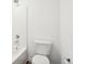 A bright bathroom with a shower-tub combo, white tile and fixtures, and chrome plumbing at 1942 Black Oak Dr, Shelbyville, IN 46176