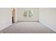 Bedroom featuring a double window, neutral carpet, and views of lush greenery at 1942 Black Oak Dr, Shelbyville, IN 46176