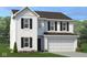 Charming two-story home with white siding, dark shutters, an attached two-car garage, and neatly landscaped front yard at 1942 Black Oak Dr, Shelbyville, IN 46176