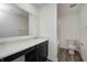 Bathroom boasts a dark wood vanity, marble countertop, and a toilet, complete with modern fixtures at 1950 Black Oak Dr, Shelbyville, IN 46176