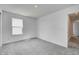 This bedroom features neutral carpet, a window for natural light, and a closet for ample storage at 1950 Black Oak Dr, Shelbyville, IN 46176