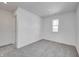 Bright bedroom with gray carpet, white walls, and a window for ample natural light at 1950 Black Oak Dr, Shelbyville, IN 46176