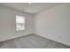 Light-filled bedroom with window and gray carpet; a serene space for rest and relaxation at 1950 Black Oak Dr, Shelbyville, IN 46176