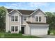 Charming two-story home with a two-car garage, gray siding, and manicured landscaping at 1950 Black Oak Dr, Shelbyville, IN 46176