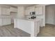 Modern kitchen featuring white cabinets, stainless steel appliances, and a center island at 1950 Black Oak Dr, Shelbyville, IN 46176